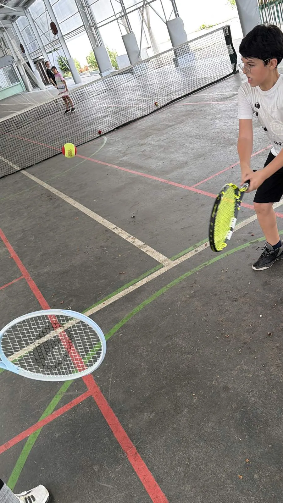 Student hitting a forehand during a rally